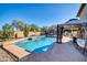 Backyard pool with a gazebo, slide and trampoline, with view of home and greenery at 13051 N 75Th Dr, Peoria, AZ 85381