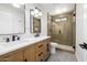 Bathroom with double sink vanity, modern fixtures, and glass-enclosed shower at 13601 N 50Th Pl, Scottsdale, AZ 85254
