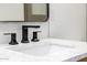 Close up of bathroom sink with modern fixtures and white backsplash tiles at 13601 N 50Th Pl, Scottsdale, AZ 85254