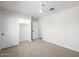 Spacious bedroom featuring neutral carpet, ceiling fan, and closet with sliding doors at 13601 N 50Th Pl, Scottsdale, AZ 85254