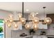 Modern chandelier with globe lights over the kitchen island enhances the bright, stylish space at 13601 N 50Th Pl, Scottsdale, AZ 85254