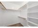 Walk-in closet featuring multiple shelves and wooden racks for optimal storage at 13601 N 50Th Pl, Scottsdale, AZ 85254