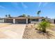 Charming single-story home featuring a three-car garage, modern curb appeal, and a desert-landscaped front yard at 13601 N 50Th Pl, Scottsdale, AZ 85254