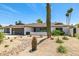 Charming single-story home featuring a three-car garage, modern curb appeal, and desert landscaping with a cactus at 13601 N 50Th Pl, Scottsdale, AZ 85254