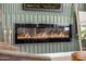 Close-up of the modern electric fireplace with wood accent wall at 13601 N 50Th Pl, Scottsdale, AZ 85254