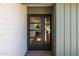 Modern front door with sidelight and textured brick facade at 13601 N 50Th Pl, Scottsdale, AZ 85254
