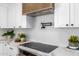 Close up of modern kitchen featuring a smooth cooktop and updated pot filler at 13601 N 50Th Pl, Scottsdale, AZ 85254