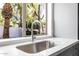 Kitchen sink featuring a modern faucet and a view of the lush backyard at 13601 N 50Th Pl, Scottsdale, AZ 85254