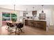 Open kitchen with island seating, modern appliances, and dining area at 13601 N 50Th Pl, Scottsdale, AZ 85254