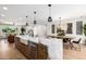 Open kitchen view featuring island with marble countertop, sink, and modern appliances at 13601 N 50Th Pl, Scottsdale, AZ 85254