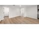 Open-concept living room featuring wood-look flooring and multiple doorways at 13601 N 50Th Pl, Scottsdale, AZ 85254