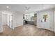 Open living room with stylish wood-look flooring flowing into the modern kitchen at 13601 N 50Th Pl, Scottsdale, AZ 85254