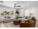 Bright living room featuring neutral furniture, ceiling fan, large window, and stylish decor at 13601 N 50Th Pl, Scottsdale, AZ 85254