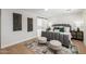 The main bedroom features neutral décor, with eye-catching wall art and a barn door to the ensuite at 13601 N 50Th Pl, Scottsdale, AZ 85254