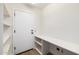 Mud room features white shelving, door to exterior, and durable flooring at 13601 N 50Th Pl, Scottsdale, AZ 85254