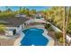 Beautiful backyard pool with an awning and a well-maintained deck at 13601 N 50Th Pl, Scottsdale, AZ 85254