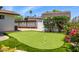 Backyard putting green with synthetic turf and manicured landscaping at 13601 N 50Th Pl, Scottsdale, AZ 85254