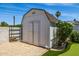 Backyard shed featuring white exterior and neutral landscaping at 13601 N 50Th Pl, Scottsdale, AZ 85254