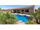 Stunning backyard pool area with tropical plants, a covered patio, and a tranquil atmosphere at 14538 W Sheridan St, Goodyear, AZ 85395