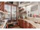 Charming bar area features custom cabinetry, granite countertops, and views to the outdoor space at 14538 W Sheridan St, Goodyear, AZ 85395