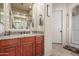 Well-lit bathroom offers granite vanity, shower, and convenient access to adjacent areas at 14538 W Sheridan St, Goodyear, AZ 85395