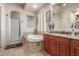 Relaxing bathroom featuring soaking tub, walk-in shower, and granite vanity at 14538 W Sheridan St, Goodyear, AZ 85395