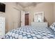 Cozy bedroom featuring a patterned duvet, white dresser, and closet with an open door at 14538 W Sheridan St, Goodyear, AZ 85395