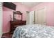 Bedroom with dark wood floors, a matching dresser, and a sliding door closet at 14538 W Sheridan St, Goodyear, AZ 85395