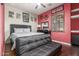 Comfortable bedroom with a full-sized bed, ceiling fan, and natural light streaming in from the window at 14538 W Sheridan St, Goodyear, AZ 85395