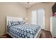 Bright bedroom with a queen size bed, matching pillows, and access to the outdoor patio at 14538 W Sheridan St, Goodyear, AZ 85395