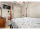 A bedroom with four poster bed with bathroom access and tile flooring at 14538 W Sheridan St, Goodyear, AZ 85395