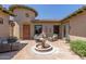 Private courtyard featuring a fountain, seating, and an arched entry door at 14538 W Sheridan St, Goodyear, AZ 85395
