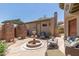 Private courtyard featuring a fountain, seating, and a pergola at 14538 W Sheridan St, Goodyear, AZ 85395