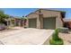 Desert home with a spacious driveway and low maintenance desert landscaping at 14538 W Sheridan St, Goodyear, AZ 85395