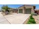 Desert home with a spacious driveway and low maintenance desert landscaping at 14538 W Sheridan St, Goodyear, AZ 85395