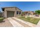 This desert home features a two car garage with an additional gated entry at 14538 W Sheridan St, Goodyear, AZ 85395