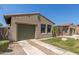 This desert home features a two car garage with an additional gated entry at 14538 W Sheridan St, Goodyear, AZ 85395