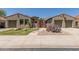 Charming home featuring desert landscaping, a gated entry, and dual two-car garages at 14538 W Sheridan St, Goodyear, AZ 85395