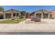 Charming home featuring desert landscaping, a gated entry, and dual two-car garages at 14538 W Sheridan St, Goodyear, AZ 85395