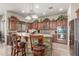 Charming kitchen boasts stone accent island, granite counters, and updated stainless appliances at 14538 W Sheridan St, Goodyear, AZ 85395