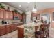 Charming kitchen features stone accent island, granite counters, and updated appliances at 14538 W Sheridan St, Goodyear, AZ 85395