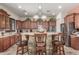 Charming kitchen boasts stone accent island, granite counters, and updated stainless appliances at 14538 W Sheridan St, Goodyear, AZ 85395