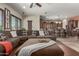 Comfortable living room features a large sectional sofa and an open floor plan to the kitchen at 14538 W Sheridan St, Goodyear, AZ 85395