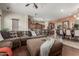 Inviting living room with a sectional sofa, open floor plan, and seamless transition to the dining area at 14538 W Sheridan St, Goodyear, AZ 85395