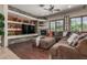 Cozy living room showcases a stone fireplace, built-in shelves, and large sectional sofa at 14538 W Sheridan St, Goodyear, AZ 85395