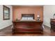 Comfortable bedroom features hardwood floors, natural light, and soothing color scheme at 14538 W Sheridan St, Goodyear, AZ 85395
