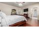 Comfortable bedroom boasts hardwood floors and access to the ensuite bathroom at 14538 W Sheridan St, Goodyear, AZ 85395