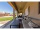 Inviting covered patio with comfortable seating, ceiling fans, and a view of the backyard at 14538 W Sheridan St, Goodyear, AZ 85395