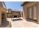 Relaxing patio space with a porch swing and an arched entryway at 14538 W Sheridan St, Goodyear, AZ 85395