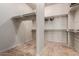 Spacious walk-in closet offering ample storage with built in shelving and hanging rods at 14538 W Sheridan St, Goodyear, AZ 85395